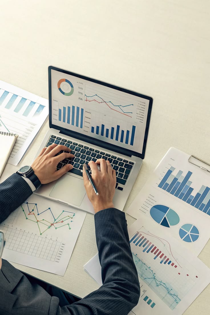 Consultant reviewing sector analytics charts on a laptop